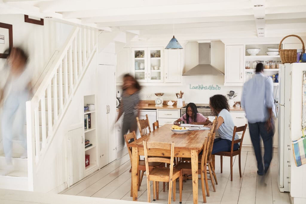 Interior Of Busy Family Home With Blurred Figures